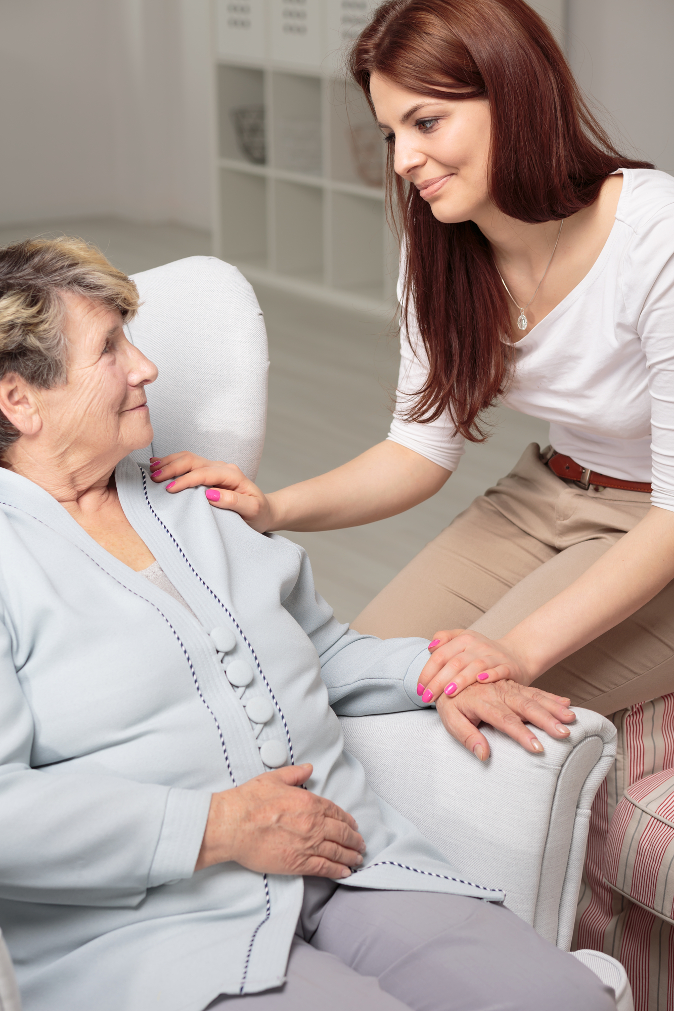Friendly caregiver taking care of smiling senior woman during meeting at home Indiana Home Health Care